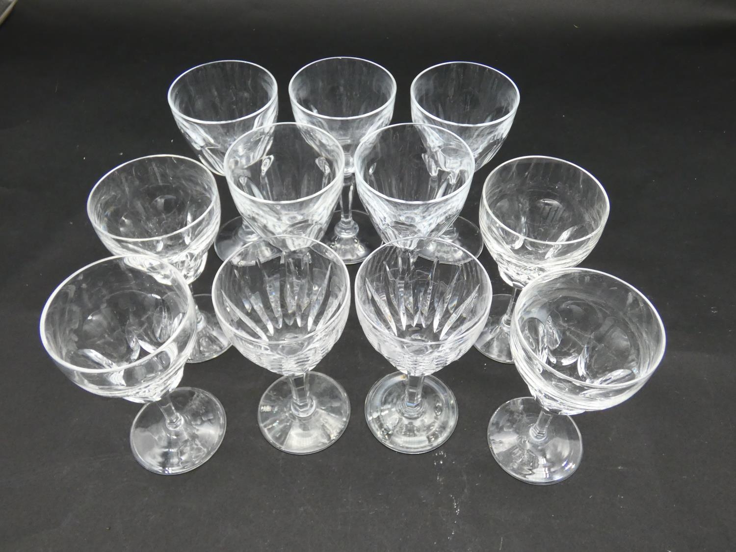 Eleven cut crystal sherry glasses with faceted petal design. H.15cm