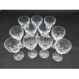 Eleven cut crystal sherry glasses with faceted petal design. H.15cm