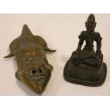 An antique oriental brass mask and seated bronze figure of a deity in lotus position. H.15cm (