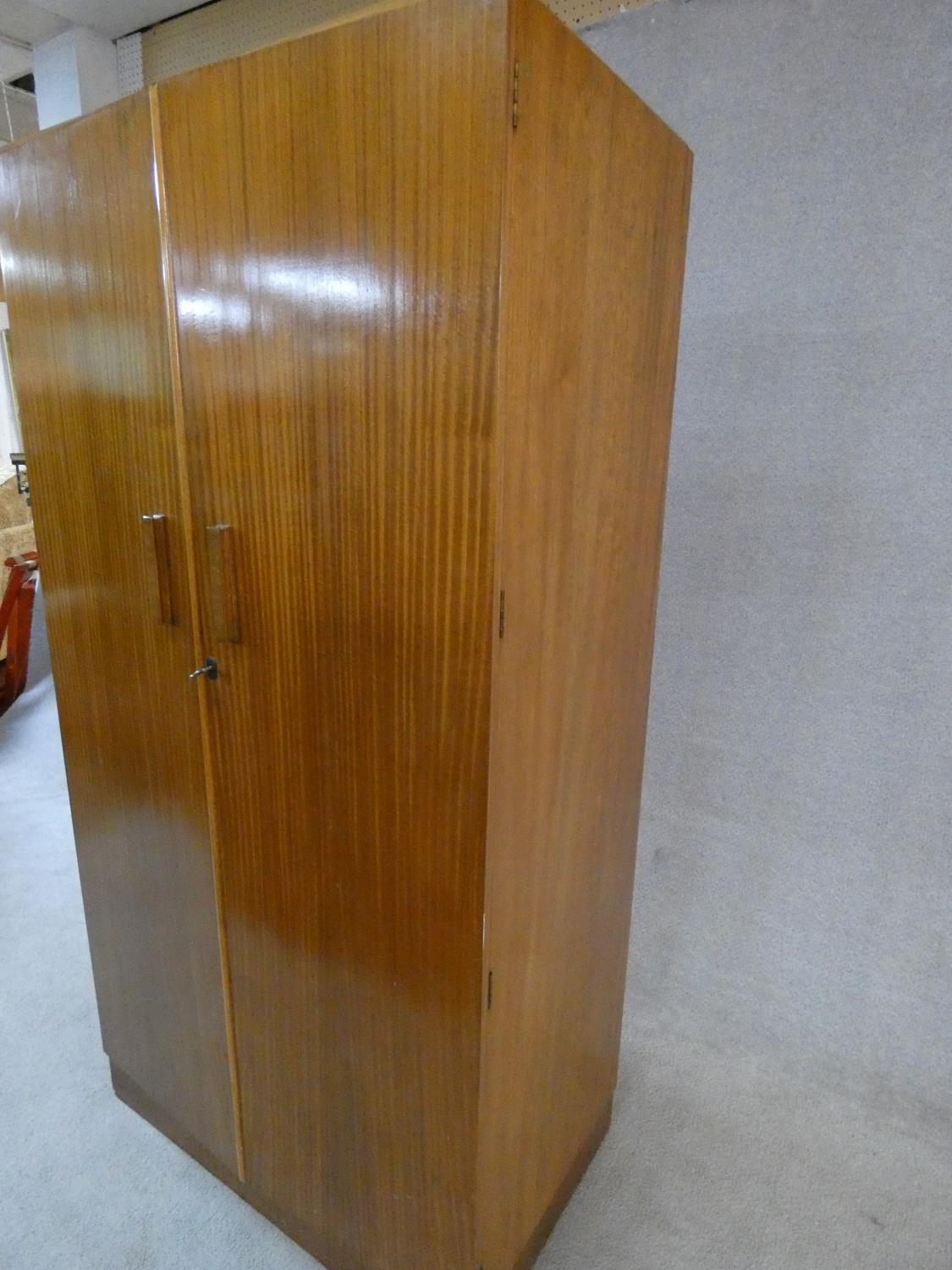 A 1960's fitted teak compactum wardrobe with inset Heal's disc to the inside of door. H.178 W.92 D. - Image 12 of 12