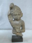 A 14th/15th century South East Asian carved sandstone figure of a deity mounted on a square