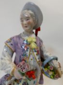 A hand painted porcelain Meissen style figure of a dandy with basket of flowers and holding a