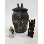 A carved wooden African tribal mask along with a carved wooden Chinese immortal and a ceramic figure