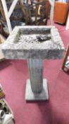 A concrete birdbath on fluted classical column pedestal. H.93 D.43cm