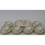 A six person part scrolling gilded design porcelain Wedgwood coffee set, pattern number W4249.