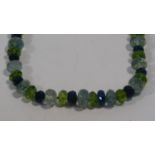 A bespoke faceted Apatite, Aquamarine and Peridot bead necklace with a silk chord loop clasp. L.42cm