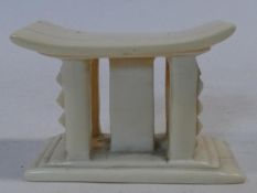 An early 20th century carved ivory African miniature headrest/ashanti stool. H.7xW.10xL.5cm