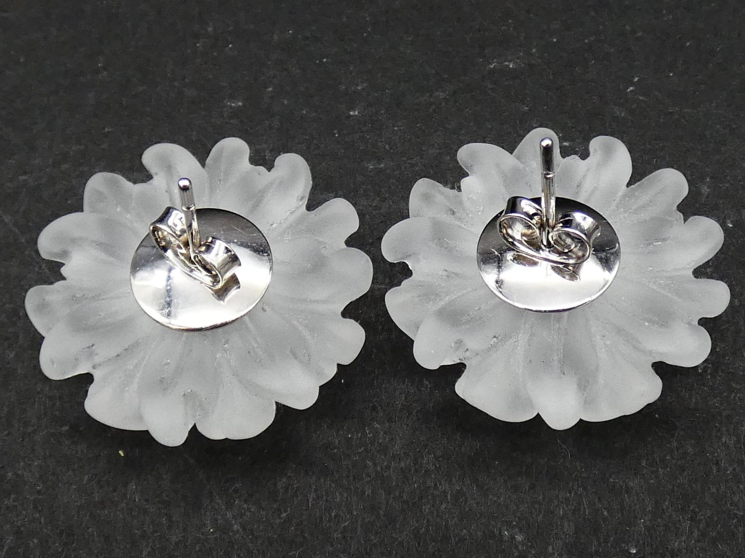 A pair of carved rock crystal daisy earrings each set to centre with a round brilliant cut - Image 3 of 3
