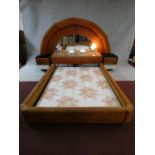 A highly unusual 1970's vintage bedstead with arched velour upholstered and mirrored head board with