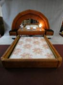 A highly unusual 1970's vintage bedstead with arched velour upholstered and mirrored head board with