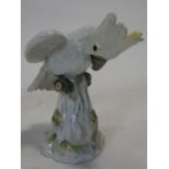 A 19th century Meissen hand painted porcelain cockatoo. With yellow crest and perched on a log.