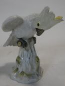 A 19th century Meissen hand painted porcelain cockatoo. With yellow crest and perched on a log.