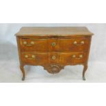 A Louis XV French provincial two drawer walnut commode of arc en arbalete outline with Rococo carved
