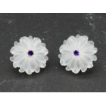 A pair of carved rock crystal daisy earrings each set to centre with a round brilliant cut