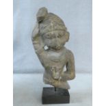 A 14th/15th century South East Asian carved sandstone figure of a deity mounted on a square