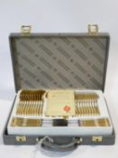 A complete canteen of SBS Bestecke Solingen 23/24 ct gold plated flatware with a repousse stylised