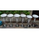 A set of six moulded seat and chrome based bar stools with adjustable rise and fall action. H.