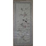 A Japanese framed and glazed silkwork embroidery of a parakeet on a branch with blossom contained