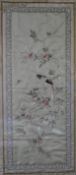 A Japanese framed and glazed silkwork embroidery of a parakeet on a branch with blossom contained