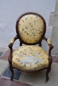 A 19th century Louis XV style open arm fauteuil in original floral silk upholstery. H.96x63cm