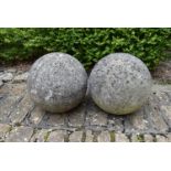 A pair of large weathered stone garden spheres. H.30cm