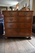 An early Georgian walnut, crossbanded and featherbanded chest of two short over three long graduated