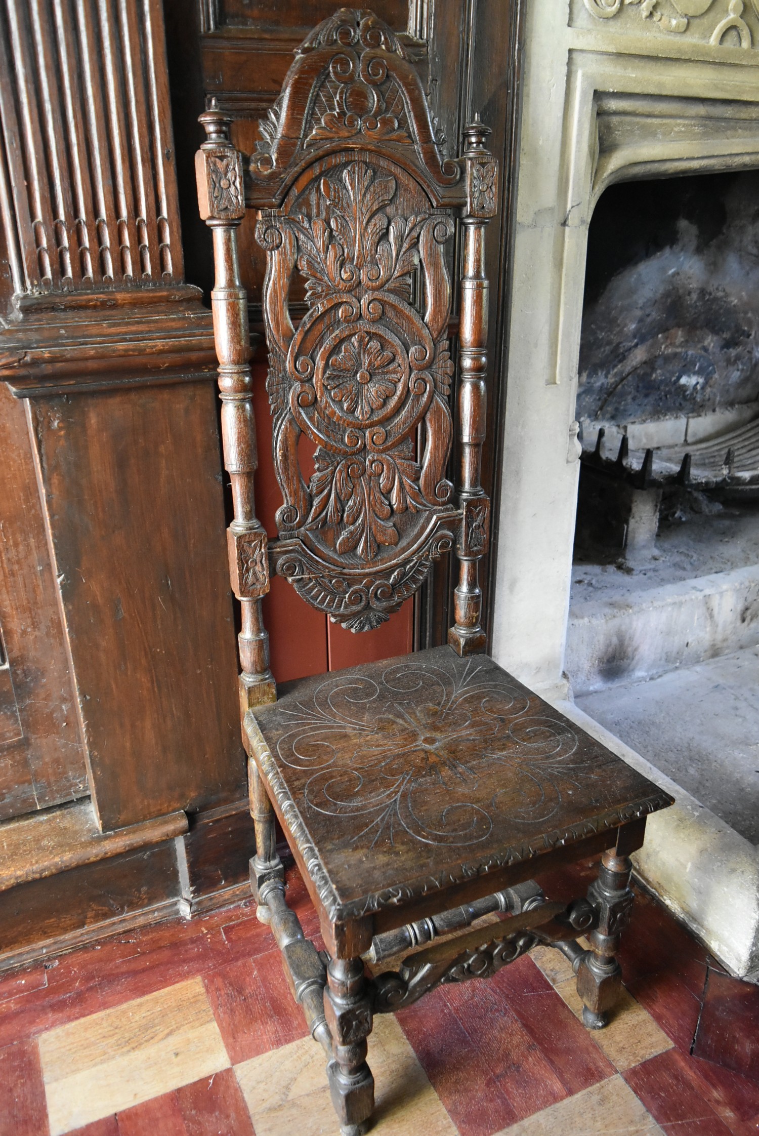 A 19th century Carolean style oak hall chair with carved arched high back above panel seat on turned - Image 2 of 3