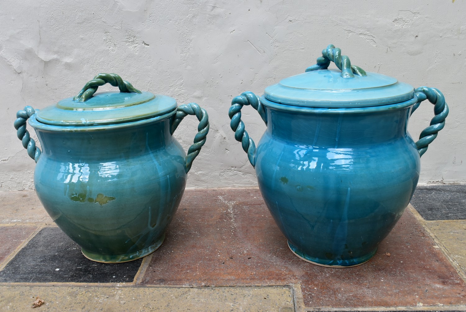 A pair of Eastern turquoise glazed lidded storage pots with twin rope design handles. H.47 x Dia.