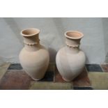 A pair of earthenware Persian Hamadan storage vessels of bulbous form with studded collars. H.95cm