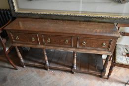 A 19th century style oak dresser base with three frieze drawers on turned supports united by pot