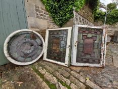 A pair of staincoloured etched and leaded glazed window frames and a similar window in circular