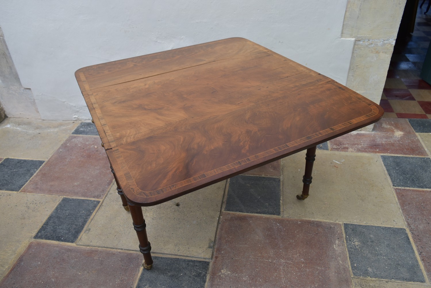 A Regency figured mahogany and rosewood crossbanded Pembroke table on ring turned tapering - Image 4 of 8