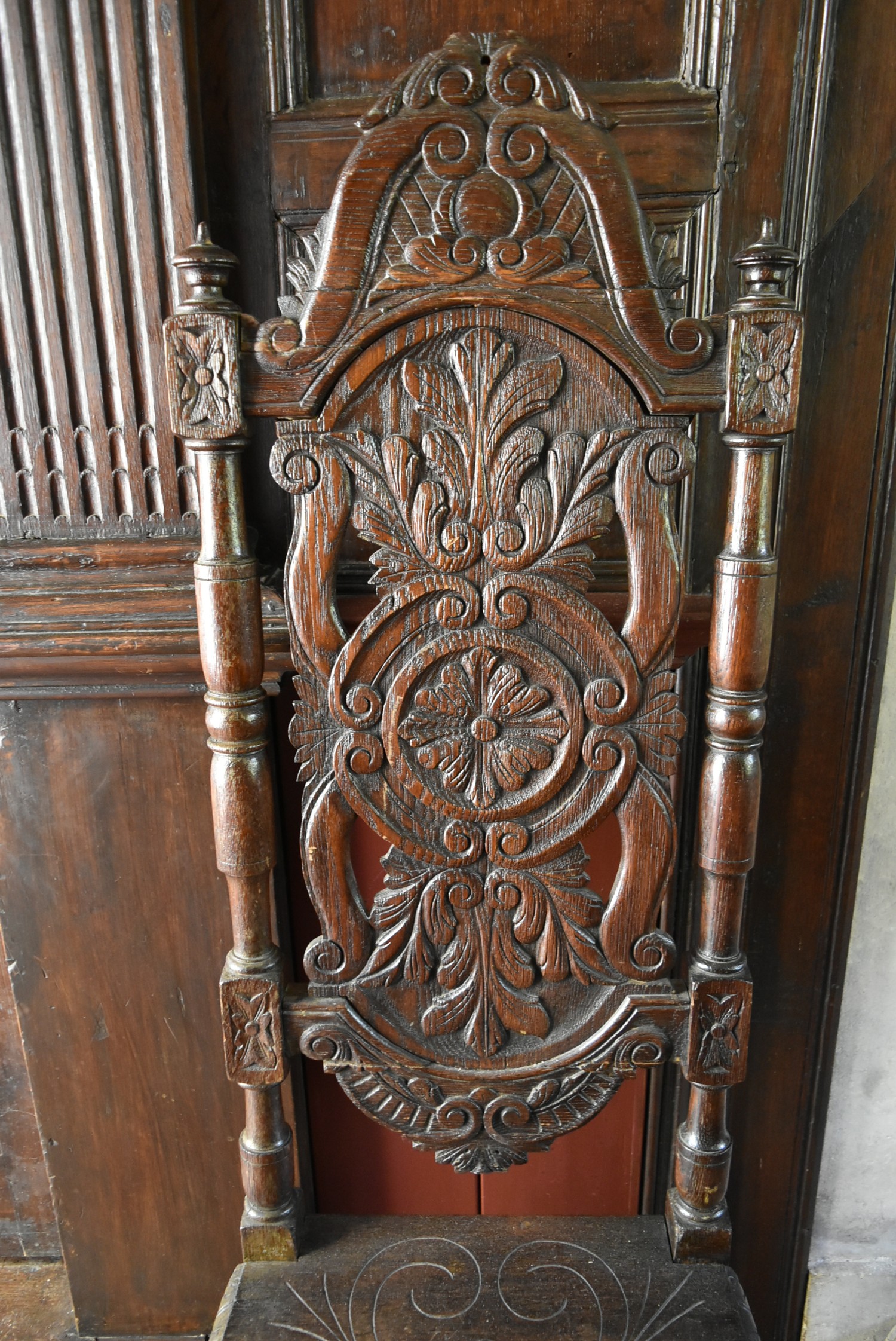 A 19th century Carolean style oak hall chair with carved arched high back above panel seat on turned - Image 3 of 3