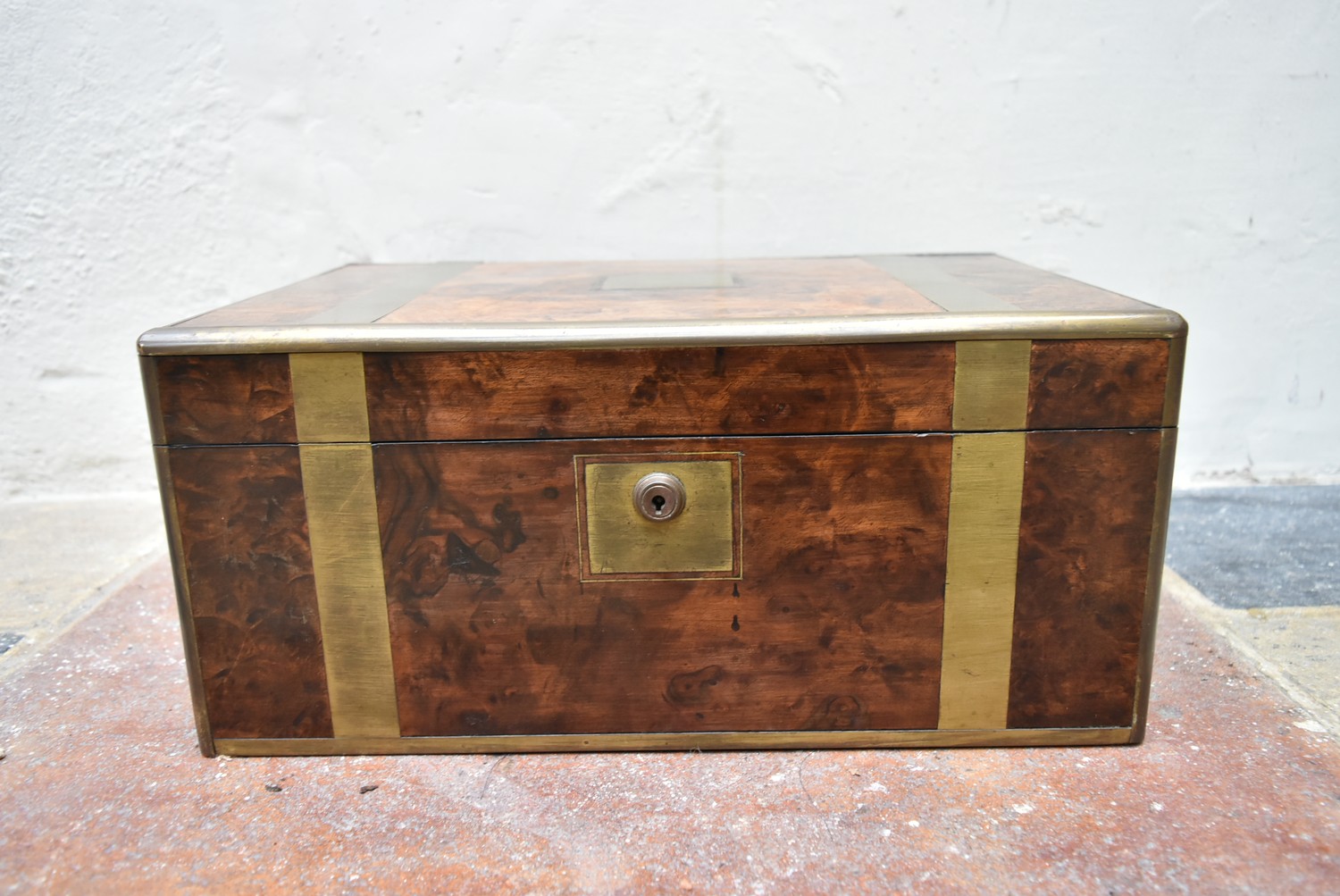 A well fitted early 19th century brass and burr walnut writing slope with inset tooled leather