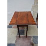 An early 19th century mahogany folding military campaign table with flap top with inset brass hinges