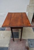 An early 19th century mahogany folding military campaign table with flap top with inset brass hinges