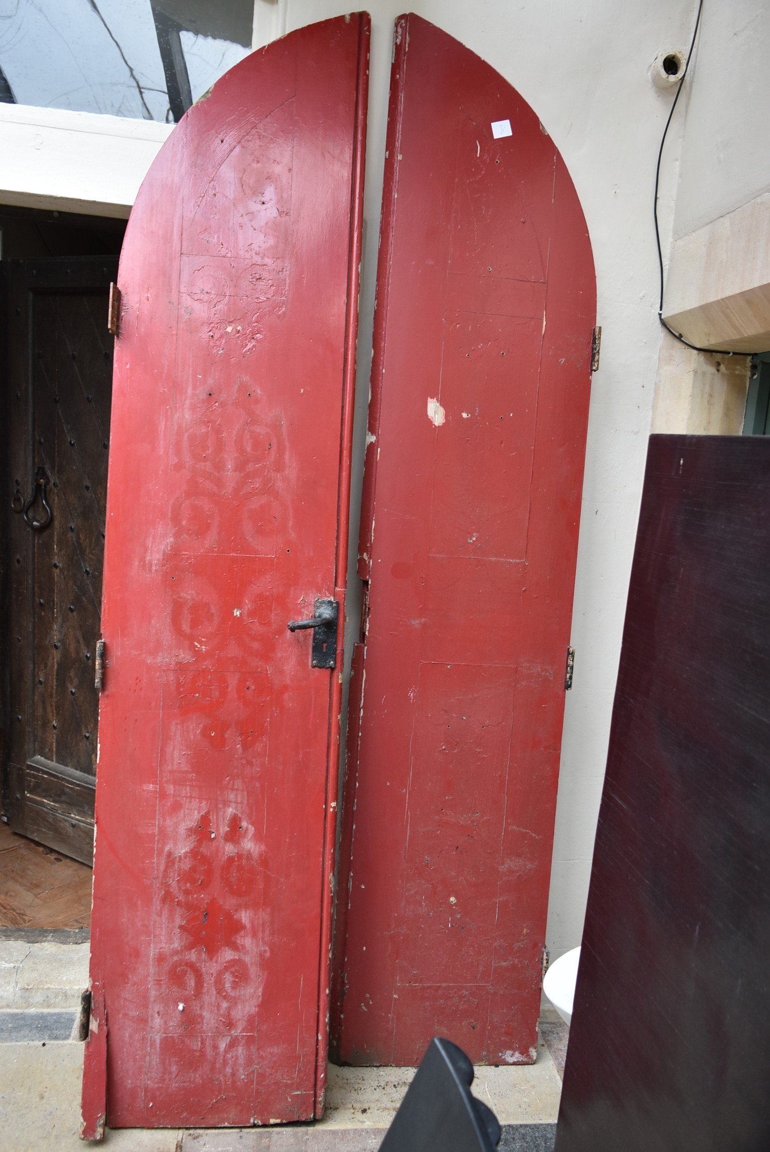 A pair of late 19th century arched and painted chapel doors with original iron handle. H.255xW.106cm