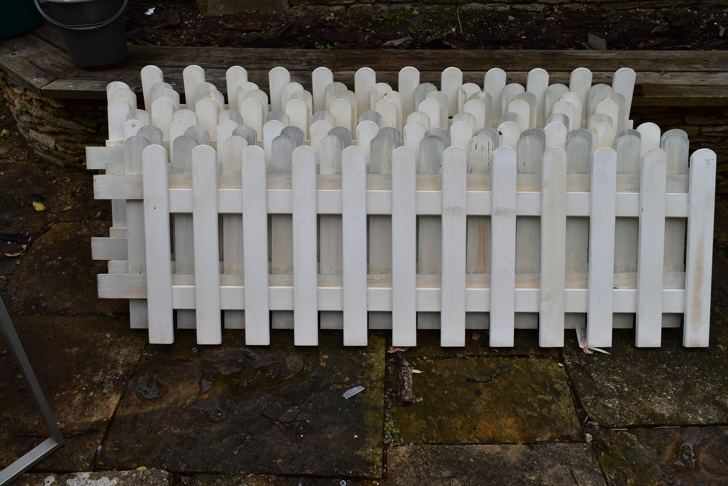 A collection of nine lengths of white painted wooden picket fencing. H.50xW.125cm