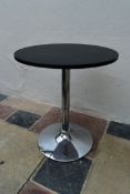 A contemporary occasional table with rise and fall action on chrome tulip base. H.70xW.60cm