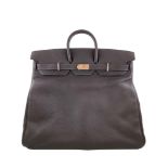 A Brown Hermes Birkin 50cm Haut A Courroies in clemence leather with gold hardware. Includes