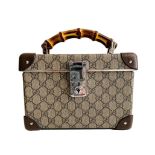 A Gucci Globe Trotter beauty case GG canvas with leather trim and bamboo handle. Includes Strap &