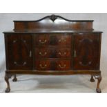 A mid century flame mahogany sideboard with cupboards and drawers on carved cabriole supports. H.125