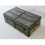 A vintage metal bound lidded travelling trunk with twin iron carrying handles. H.32xW.92xD.53cm