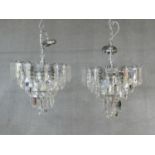 A pair of ceiling chandeliers with clear perspex lozenge form drops. H.60 D.40cm