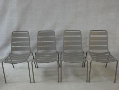 A set of four metal framed stacking garden chairs. H.84cm