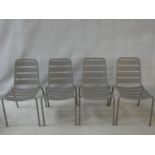 A set of four metal framed stacking garden chairs. H.84cm