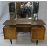 A mid century vintage teak G-Plan dressing table with adjustable triple mirrors above drawers on