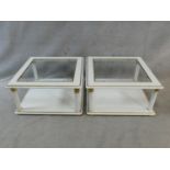 A pair of contemporary white lacquered two tier low tables with inset plate glass tops. H.43 L.80