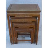 A nest of four Chinese hardwood graduating occasional tables with carved frieze on shaped