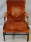 A 19th century mahogany Gainsborough armchair in velour upholstery on moulded square stretched